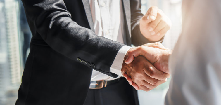 Business professionals shaking hands in agreement